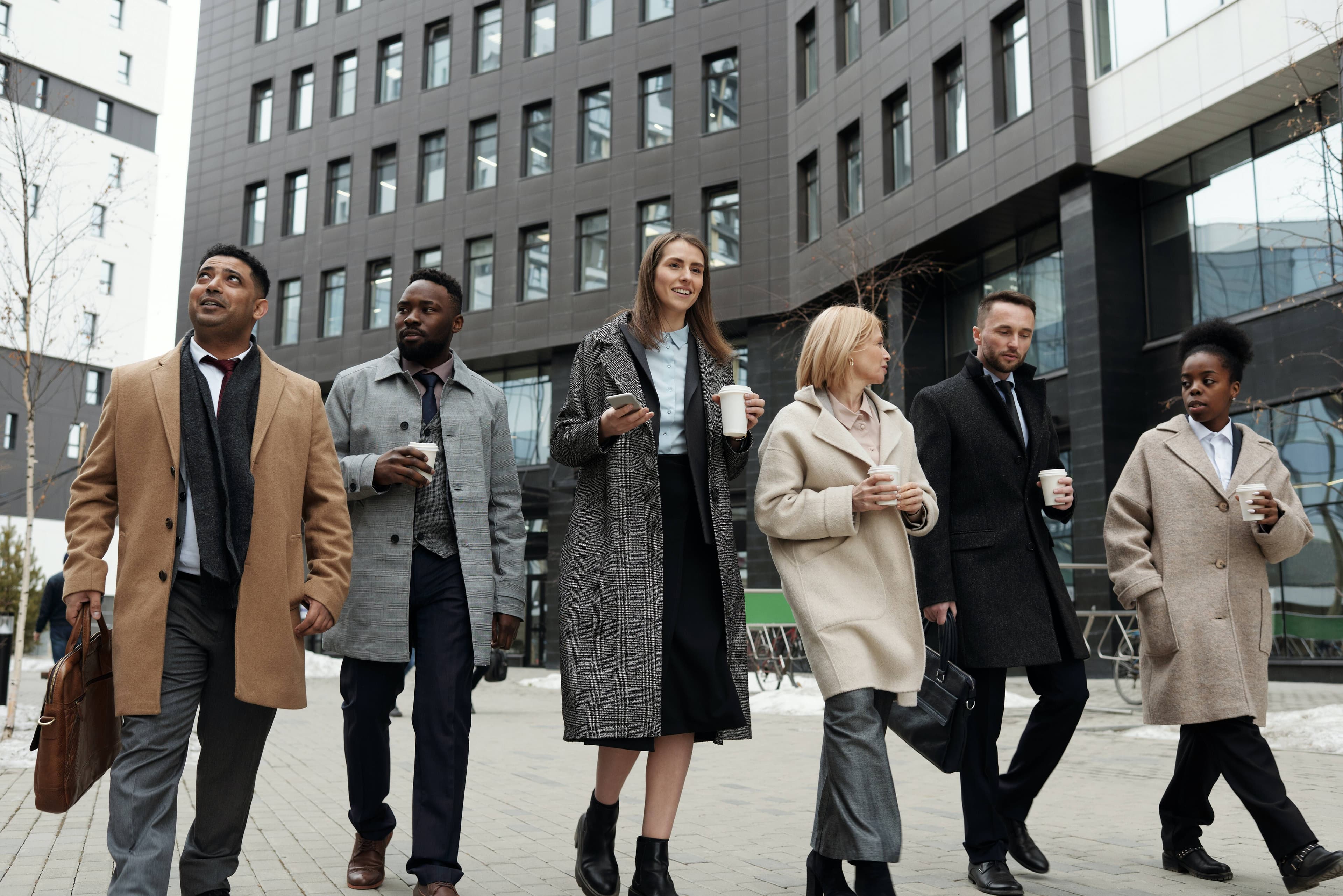 People Walking In Front of Office